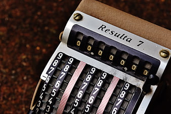 Close-up of vintage Resulta 7 mechanical calculator with numbered dials