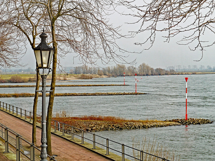 Winter Riverside Promenade with Vintage Lamp Post and River Markers