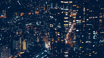 Aerial Night View of Dense Urban Cityscape with Glowing Windows