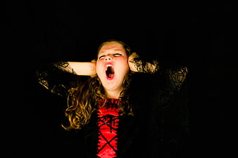 Girl in Halloween Costume Screaming with Hands on Ears