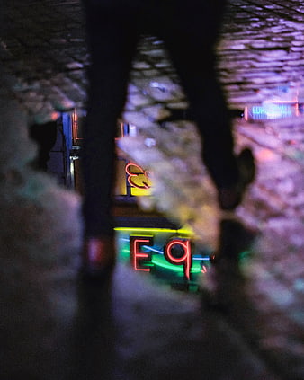 Neon Reflection in Wet Street Puddle at Night
