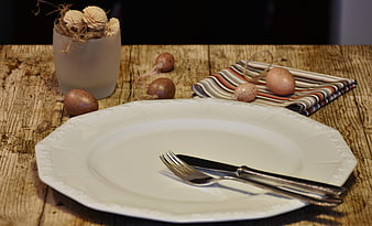Rustic Easter Table Setting With White Porcelain Plate And Cutlery
