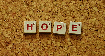 Scrabble Tiles Spelling Hope on Cork Board