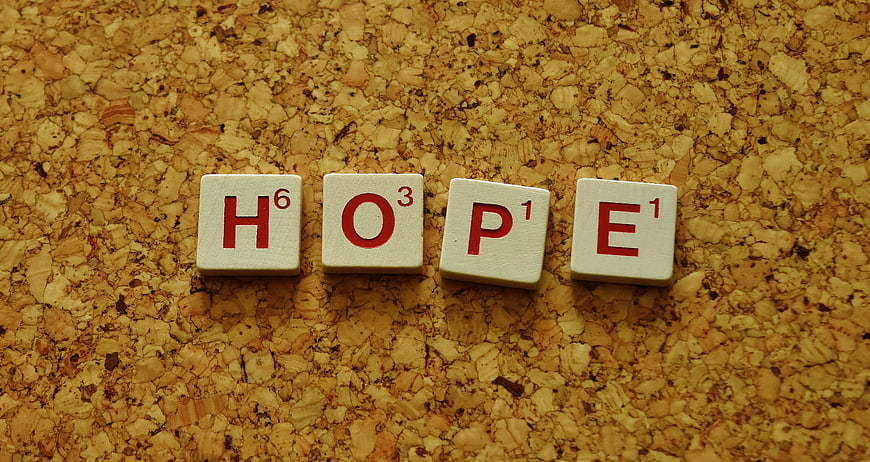 Scrabble Tiles Spelling Hope on Cork Board