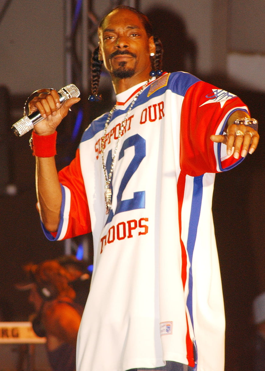 Snoop Dogg performing on stage in Support Our Troops jersey