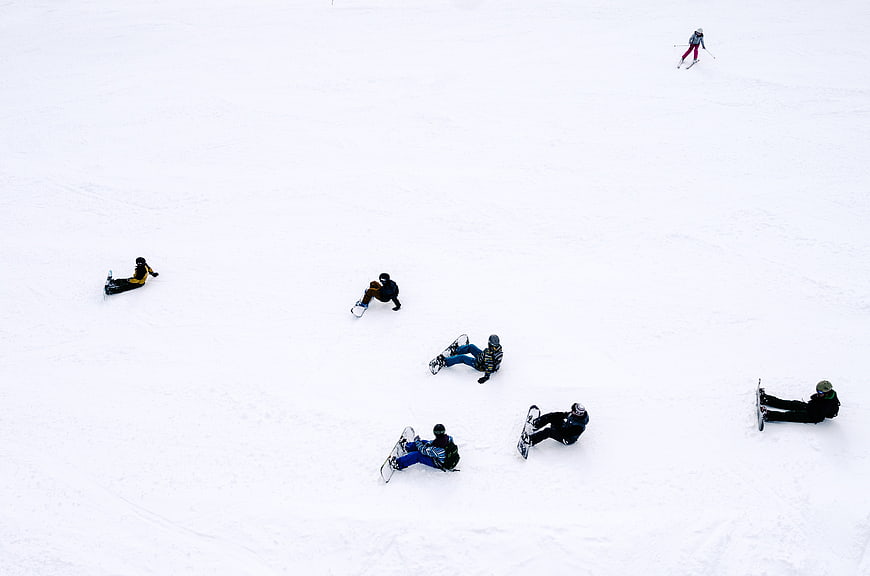 High Angle View of Snowboarders Resting on White Slope