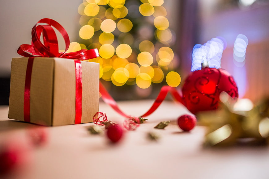 Brown Christmas Gift Box with Red Ribbon and Bokeh Lights