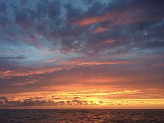 Dramatic Sunset Over The Ocean With Colorful Clouds