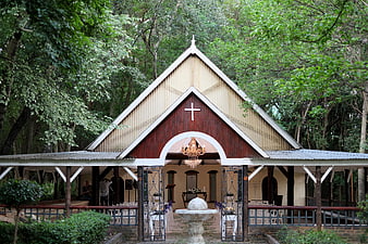 Rustic wooden chapel in forest with wedding setup