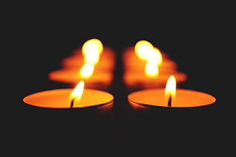 Glowing Tea Lights on Black Background