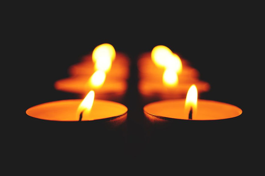 Glowing Tea Lights on Black Background