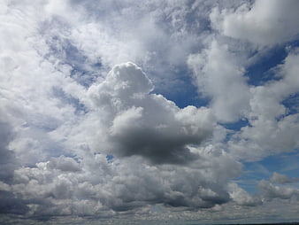Dramatic Cumulus Clouds Against Blue Sky