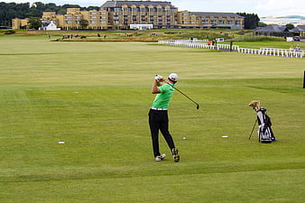 Golfer swinging on fairway at St Andrews Old Course