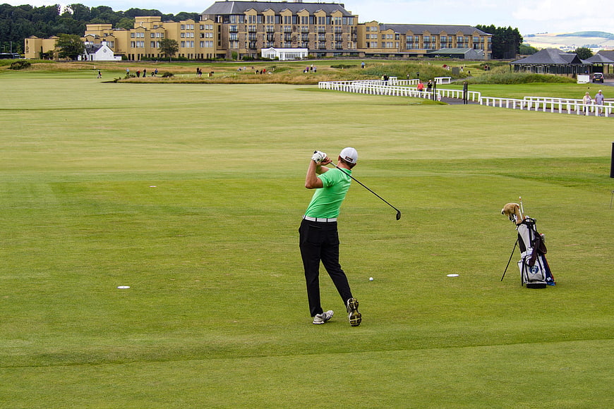 Golfer swinging on fairway at St Andrews Old Course