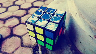 Rubik's Cube with Sky Reflection on Cobblestones