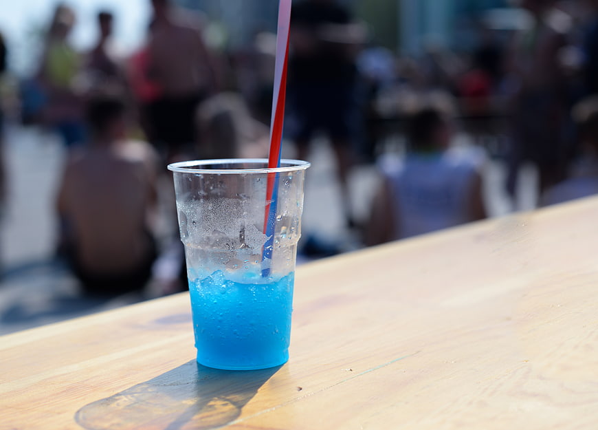 Blue Slushy Drink in Plastic Cup on Wooden Table