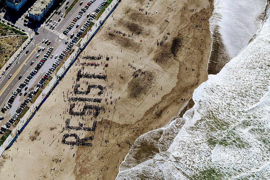 Aerial view of human chain protest on beach