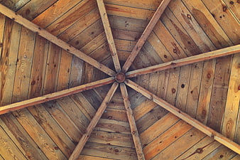 Wooden gazebo ceiling with radial beams and planks