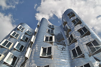 Low angle view of wavy silver modern architecture