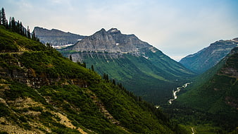 Majestic mountain valley with winding river and lush green slopes
