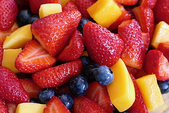 Close-up of fresh strawberry, blueberry, and mango fruit salad