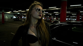 Stylish Woman in Sunglasses Standing in Parking Garage