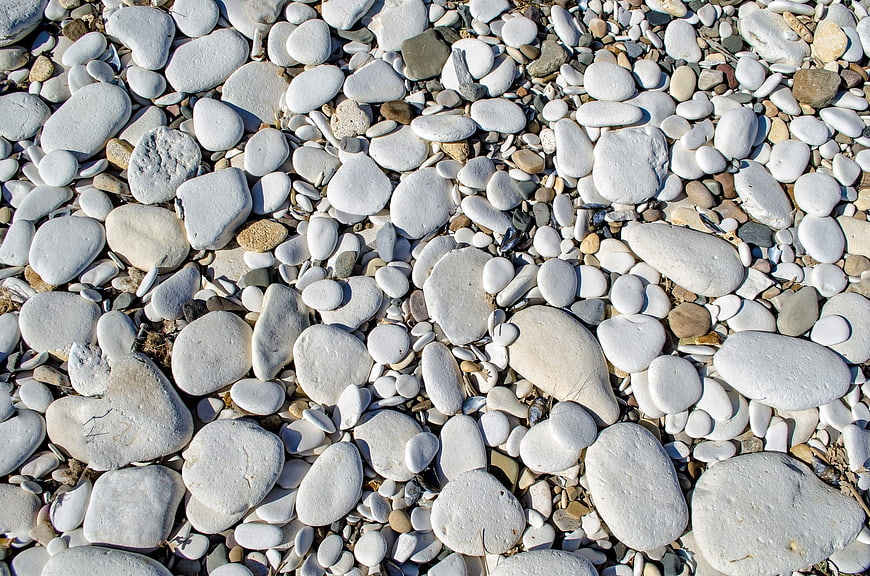 Close-up of smooth white pebbles and stones on a beach