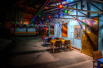 Empty outdoor restaurant patio with colorful string lights at night