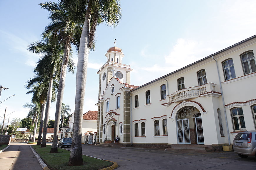 White colonial church with palm trees in tropical town