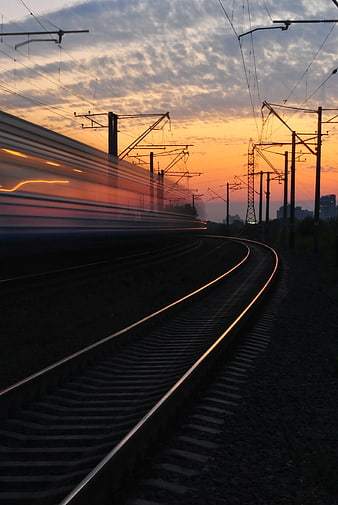 High Speed Train Motion Blur on Tracks at Sunset