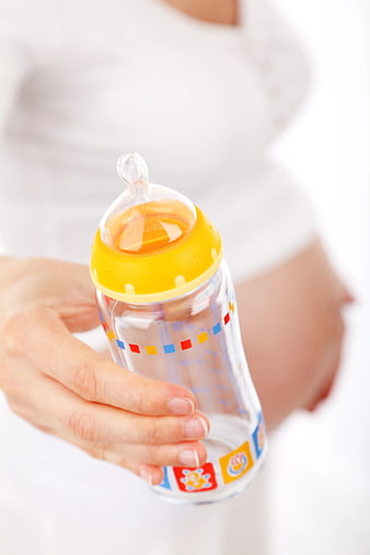 Pregnant Woman Holding Baby Bottle