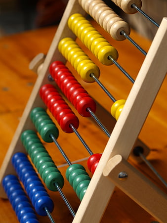 Colorful wooden abacus with beads on metal rods