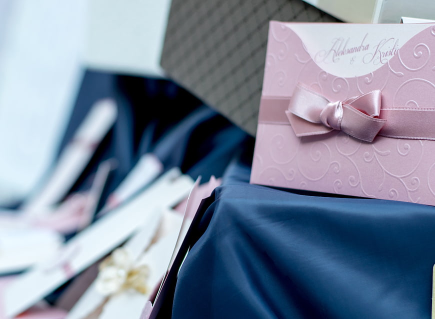 Pink Wedding Invitation with Ribbon on Blue Fabric