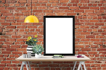 Interior mockup with empty black frame on wooden table against brick wall