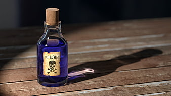 Vintage Poison Bottle with Skull Label on Wooden Table