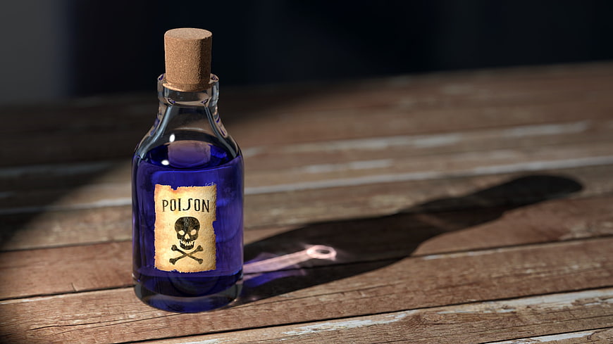 Vintage Poison Bottle with Skull Label on Wooden Table