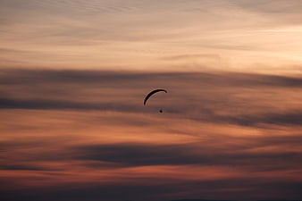 Paraglider Silhouette Against Dramatic Sunset Sky