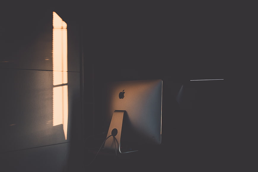 Minimalist Apple iMac in Dark Room with Window Light