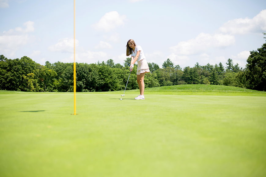 Woman Putting on Golf Course Green