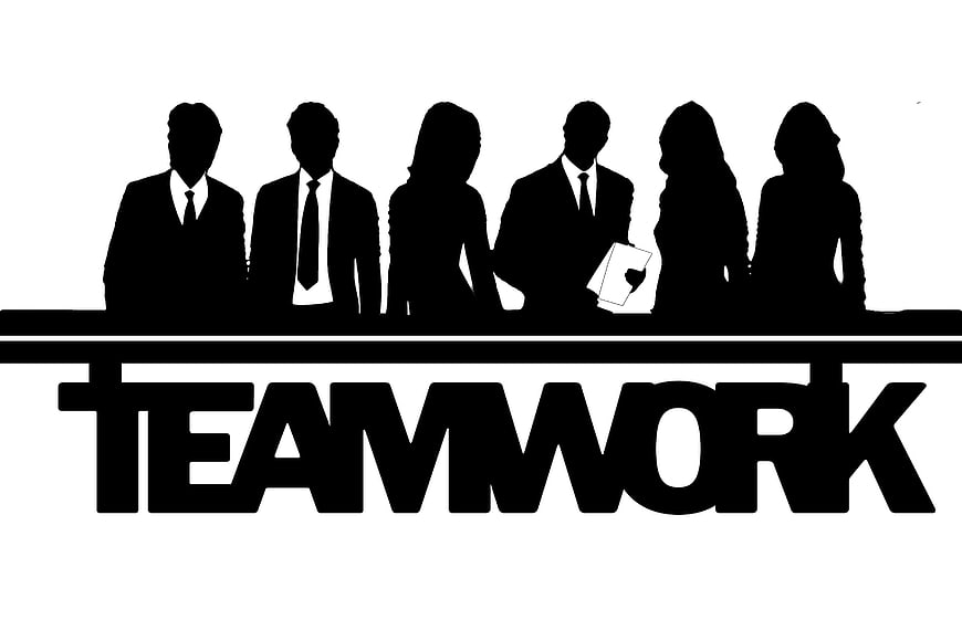 Black silhouette of business team standing behind teamwork text