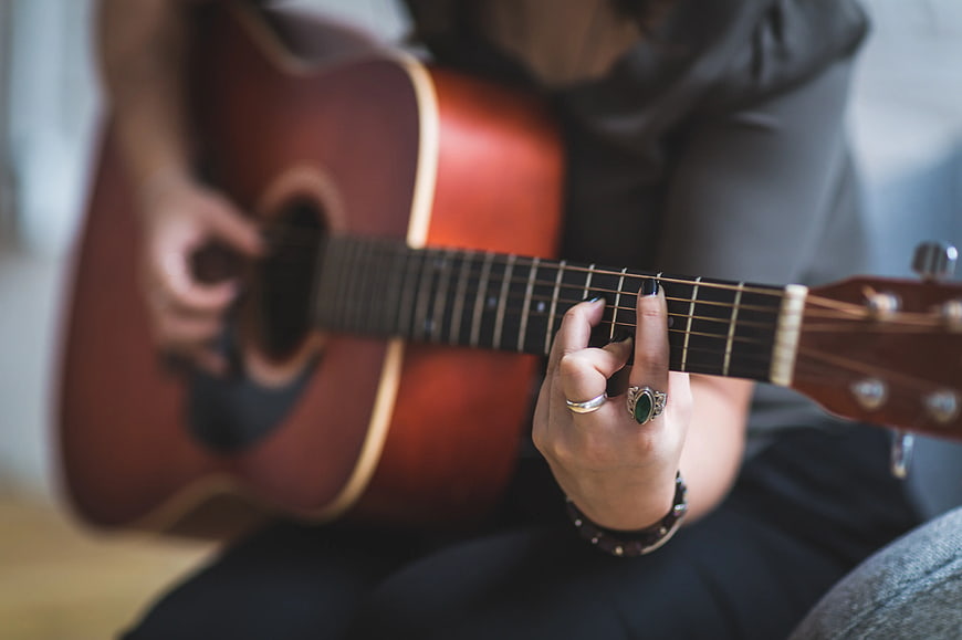 Close-up of Woman Playing Acoustic Guitar
