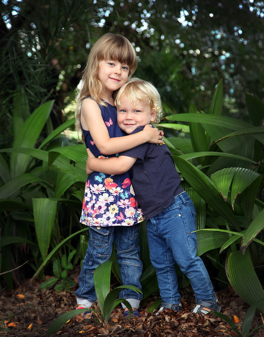 Happy Siblings Embracing Outdoors