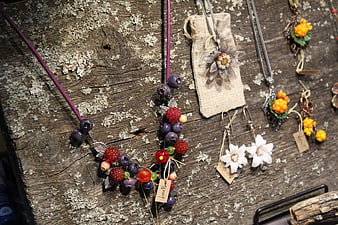 Handmade berry and flower jewelry on rustic wood
