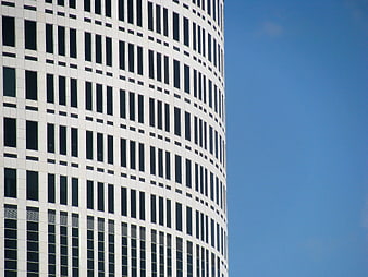 Modern Curved Skyscraper Facade Against Blue Sky
