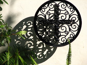 Black Wrought Iron Wall Decor with Intricate Shadow Pattern