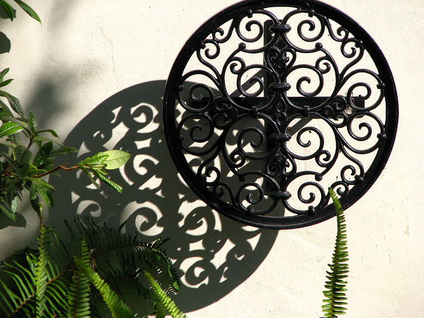 Black Wrought Iron Wall Decor with Intricate Shadow Pattern