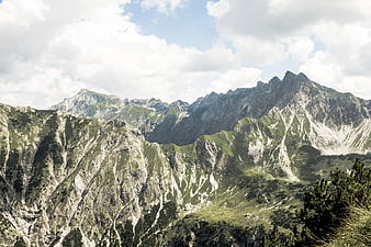 Majestic Mountain Landscape with Green Slopes and Cloudy Sky