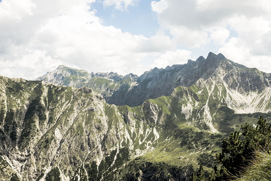 Majestic Mountain Landscape with Green Slopes and Cloudy Sky