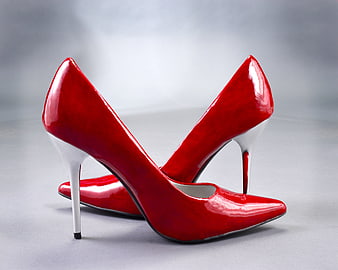 Pair of glossy red high heel pumps with white stiletto heels