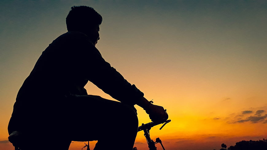 Silhouette of Cyclist Riding at Sunset
